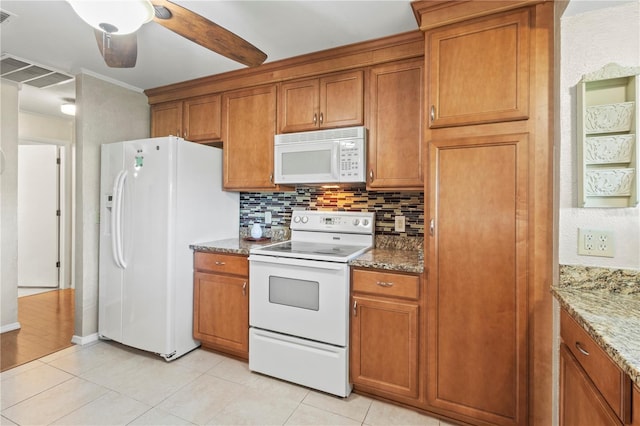 8606 Gold Pine Dr, Port Richey, FL 34668 - kitchen featuring white appliances, brown cabinets, tasteful backsplash, and light tile patterned floors