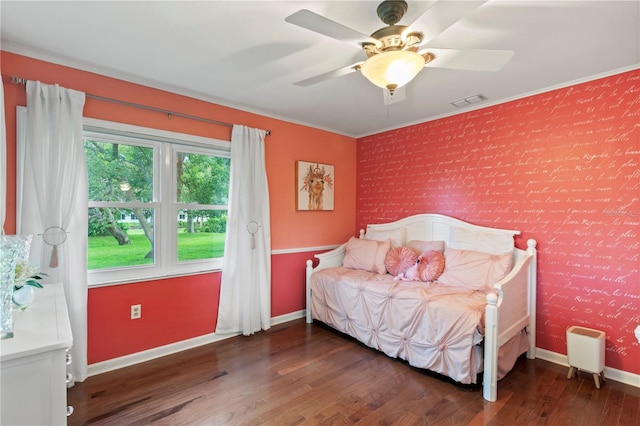 8606 Gold Pine Dr, Port Richey, FL 34668 - bedroom featuring an accent wall, ornamental molding, wood finished floors, a ceiling fan, and wallpapered walls