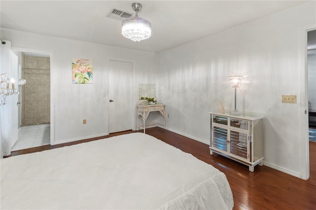 8606 Gold Pine Dr, Port Richey, FL 34668 - bedroom with a chandelier, wood finished floors, and connected bathroom