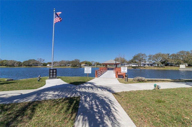 8606 Gold Pine Dr, Port Richey, FL 34668 - dock featuring a gazebo, a water view, and a lawn