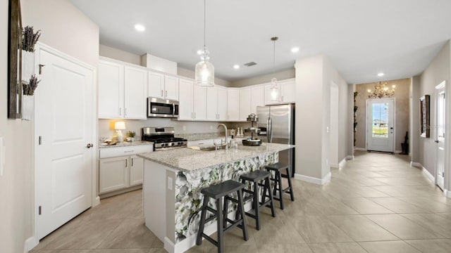 15992 Honey Suckle St, Port Charlotte, FL 33953 - kitchen featuring appliances with stainless steel finishes, a kitchen breakfast bar, a kitchen island with sink, white cabinets, and recessed lighting
