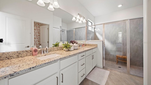 15992 Honey Suckle St, Port Charlotte, FL 33953 - bathroom with a chandelier, double vanity, a stall shower, and tile patterned flooring
