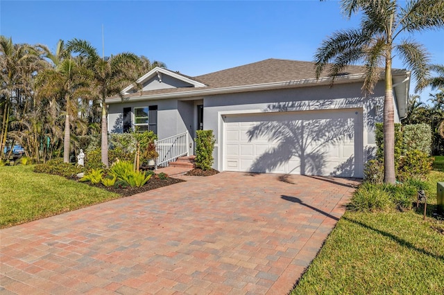 24748 Rio Villa Lakes Cir, Punta Gorda, FL 33950 - ranch-style home with stucco siding, an attached garage, decorative driveway, and a front yard