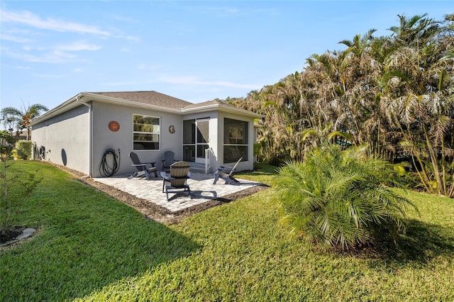 24748 Rio Villa Lakes Cir, Punta Gorda, FL 33950 - rear view of property featuring a patio area, a yard, stucco siding, and a sunroom