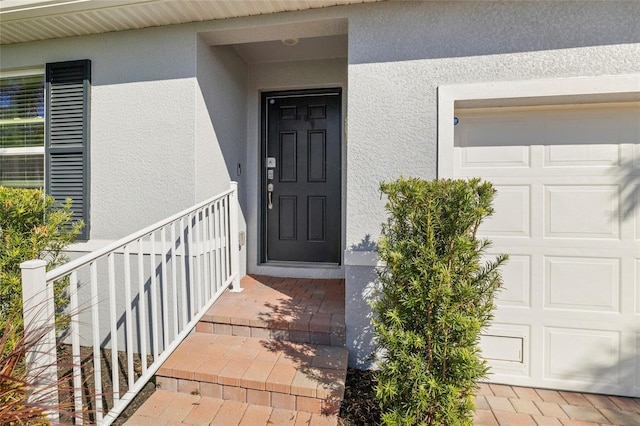 24748 Rio Villa Lakes Cir, Punta Gorda, FL 33950 - doorway to property featuring stucco siding and a garage