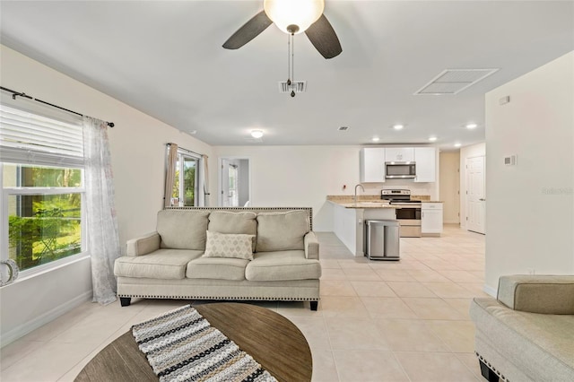 24748 Rio Villa Lakes Cir, Punta Gorda, FL 33950 - living area with light tile patterned flooring, ceiling fan, and recessed lighting