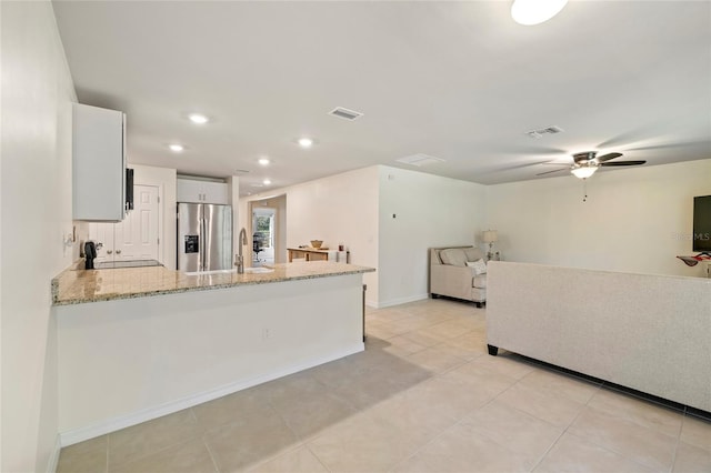 24748 Rio Villa Lakes Cir, Punta Gorda, FL 33950 - kitchen with stainless steel refrigerator with ice dispenser, stove, light stone counters, a peninsula, and ceiling fan