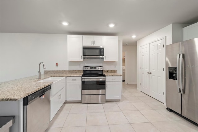 24748 Rio Villa Lakes Cir, Punta Gorda, FL 33950 - kitchen with stainless steel appliances, a peninsula, white cabinetry, light stone countertops, and recessed lighting