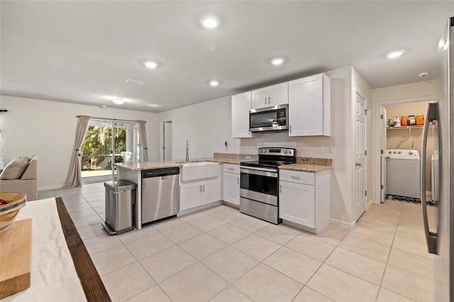 24748 Rio Villa Lakes Cir, Punta Gorda, FL 33950 - kitchen featuring stainless steel appliances, washer / clothes dryer, a peninsula, light tile patterned floors, and recessed lighting