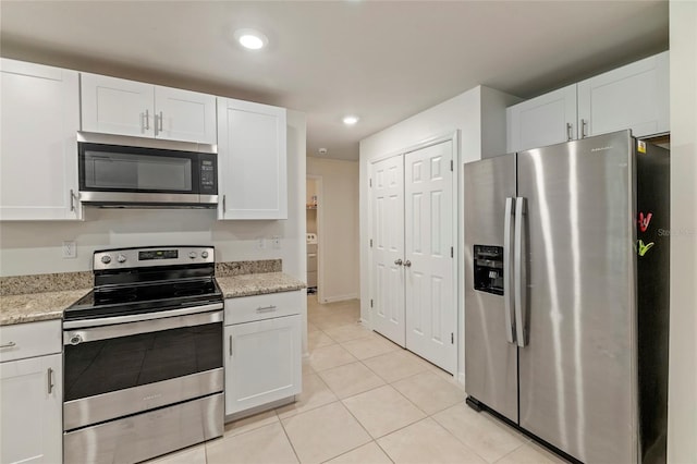 24748 Rio Villa Lakes Cir, Punta Gorda, FL 33950 - kitchen with appliances with stainless steel finishes, white cabinets, light tile patterned floors, recessed lighting, and light stone counters