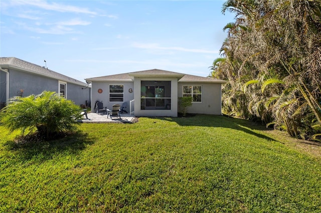 24748 Rio Villa Lakes Cir, Punta Gorda, FL 33950 - back of property featuring a patio, a lawn, and stucco siding