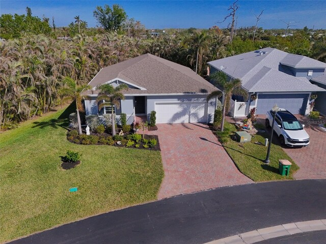 24748 Rio Villa Lakes Cir, Punta Gorda, FL 33950 - ranch-style home with an attached garage, decorative driveway, and a front lawn