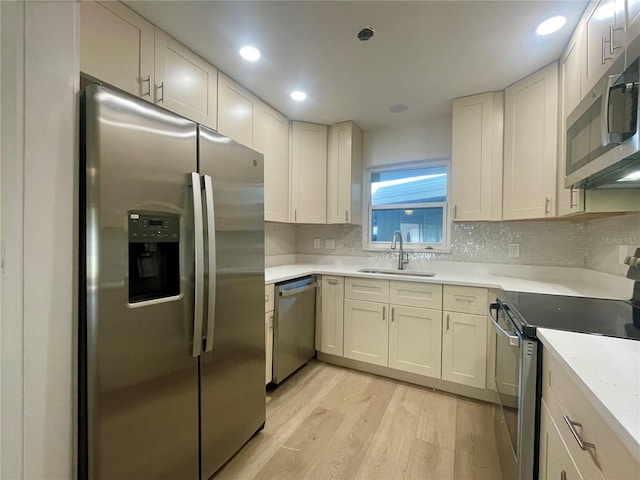 6300 Flotilla Dr Unit 71, Holmes Beach, FL 34217 - kitchen with stainless steel appliances, light wood-type flooring, tasteful backsplash, light countertops, and recessed lighting