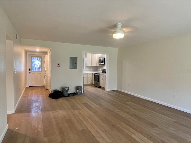 6300 Flotilla Dr Unit 71, Holmes Beach, FL 34217 - unfurnished living room with electric panel, wood finished floors, and a ceiling fan
