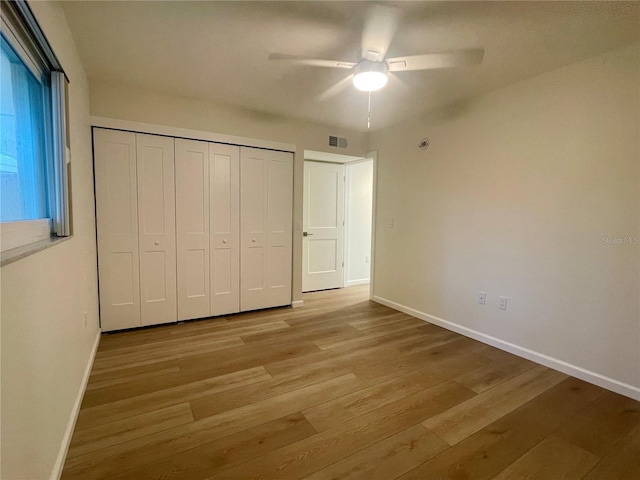 6300 Flotilla Dr Unit 71, Holmes Beach, FL 34217 - unfurnished bedroom featuring light wood-style floors, a closet, and ceiling fan