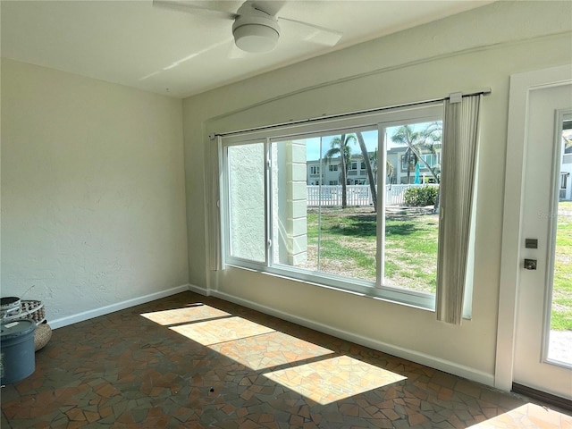 6300 Flotilla Dr Unit 71, Holmes Beach, FL 34217 - unfurnished room featuring healthy amount of natural light, ceiling fan, and stone finish floors