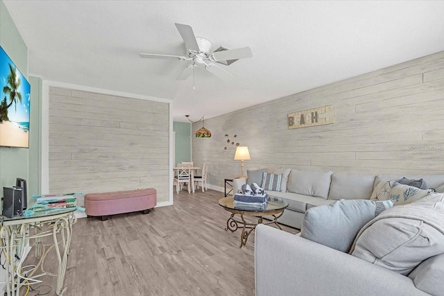 201 75th St Unit A, Holmes Beach, FL 34217 - living room with wooden walls, ceiling fan, and wood finished floors