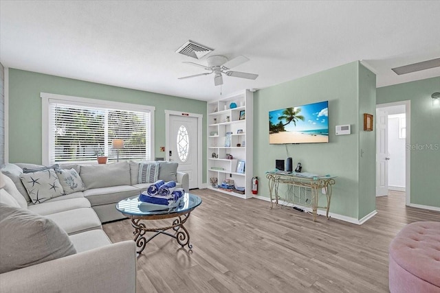 201 75th St Unit A, Holmes Beach, FL 34217 - living room with wood finished floors, ceiling fan, and built in features
