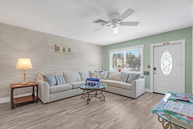 201 75th St Unit A, Holmes Beach, FL 34217 - living room with light wood-type flooring, ceiling fan, and wood walls