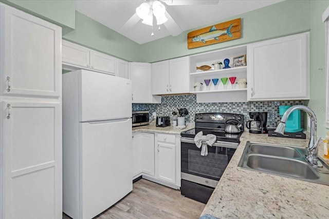 201 75th St Unit A, Holmes Beach, FL 34217 - kitchen featuring stainless steel appliances, white cabinetry, and a ceiling fan