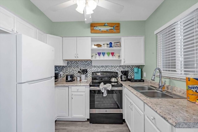 201 75th St Unit A, Holmes Beach, FL 34217 - kitchen featuring freestanding refrigerator, electric stove, a ceiling fan, open shelves, and white cabinetry