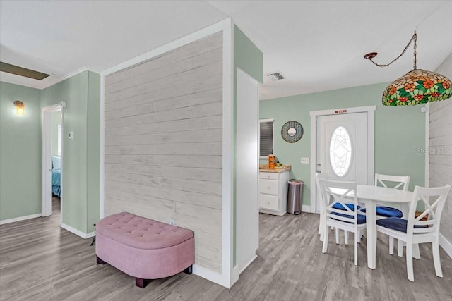 201 75th St Unit A, Holmes Beach, FL 34217 - dining space with wood finished floors and wood walls