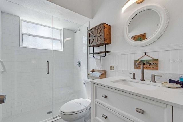 201 75th St Unit A, Holmes Beach, FL 34217 - bathroom with a stall shower, vanity, and a wainscoted wall