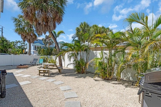 201 75th St Unit A, Holmes Beach, FL 34217 - fenced backyard with an outdoor fire pit and a patio