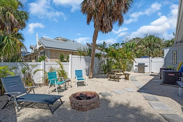 201 75th St Unit A, Holmes Beach, FL 34217 - fenced backyard featuring an outdoor fire pit and a patio area