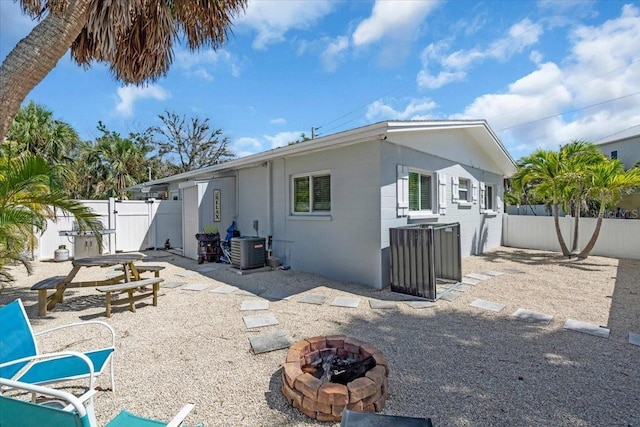 201 75th St Unit A, Holmes Beach, FL 34217 - back of house featuring a fire pit, a fenced backyard, a gate, and a patio