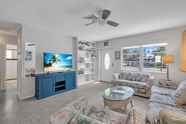 201 75th St Unit A, Holmes Beach, FL 34217 - living area with dark speckled floor and a ceiling fan