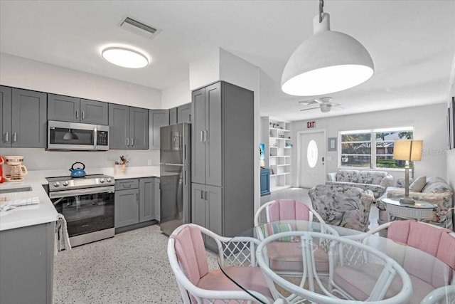 201 75th St Unit A, Holmes Beach, FL 34217 - kitchen featuring stainless steel appliances, open floor plan, gray cabinetry, a ceiling fan, and dark speckled floor