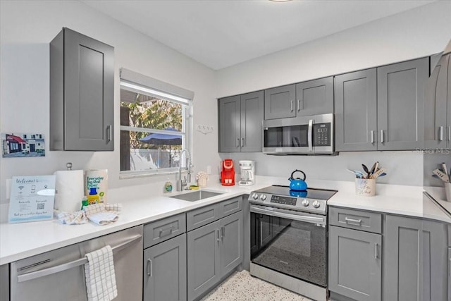 201 75th St Unit A, Holmes Beach, FL 34217 - kitchen featuring stainless steel appliances, gray cabinets, and light countertops