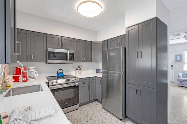 201 75th St Unit A, Holmes Beach, FL 34217 - kitchen featuring appliances with stainless steel finishes, dark aggregate flooring, light countertops, and gray cabinets