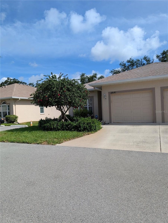2641 73rd Ct W Unit 124, Bradenton, FL 34209 - ranch-style house with concrete driveway, stucco siding, and an attached garage