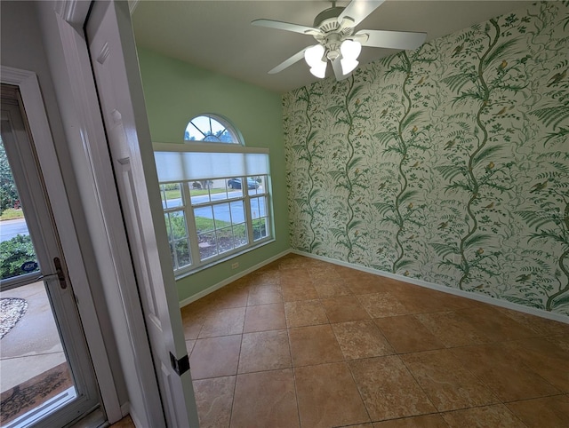 2641 73rd Ct W Unit 124, Bradenton, FL 34209 - unfurnished room featuring wallpapered walls, lofted ceiling, and ceiling fan