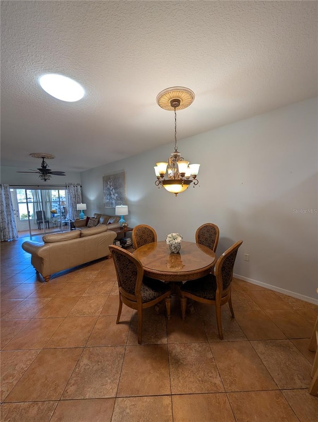 2641 73rd Ct W Unit 124, Bradenton, FL 34209 - dining area featuring a textured ceiling, a chandelier, and light tile patterned flooring