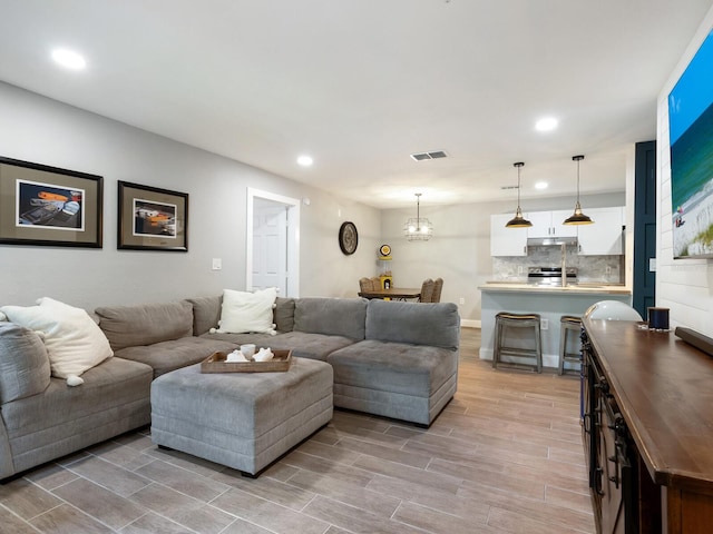 7424 Vista Way Unit 104, Bradenton, FL 34202 - living area with recessed lighting, light wood finished floors, and a chandelier