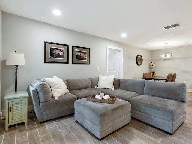 7424 Vista Way Unit 104, Bradenton, FL 34202 - living room with wood tiled floors, a chandelier, and recessed lighting