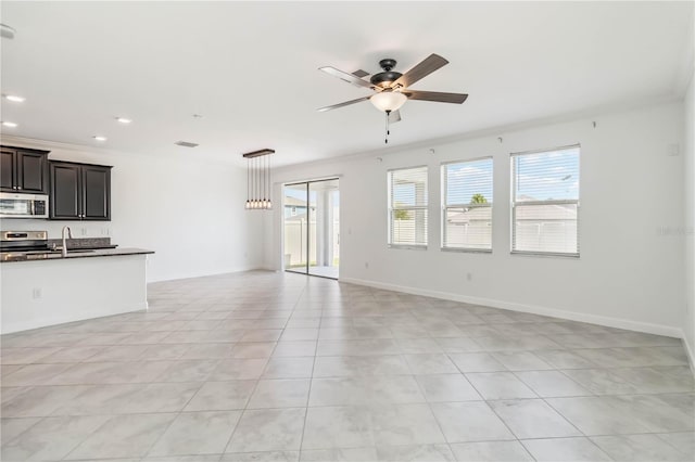 9629 Ivory Dr, Ruskin, FL 33573 - unfurnished living room featuring ceiling fan, plenty of natural light, light tile patterned floors, recessed lighting, and crown molding