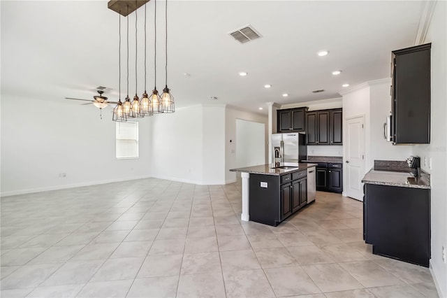 9629 Ivory Dr, Ruskin, FL 33573 - kitchen featuring crown molding, stainless steel appliances, a center island with sink, open floor plan, and light tile patterned floors
