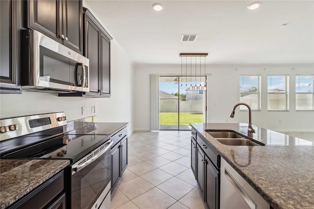 9629 Ivory Dr, Ruskin, FL 33573 - kitchen featuring appliances with stainless steel finishes, healthy amount of natural light, dark stone countertops, and recessed lighting