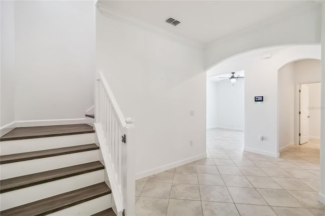 9629 Ivory Dr, Ruskin, FL 33573 - stairs with ceiling fan, arched walkways, tile patterned flooring, and ornamental molding