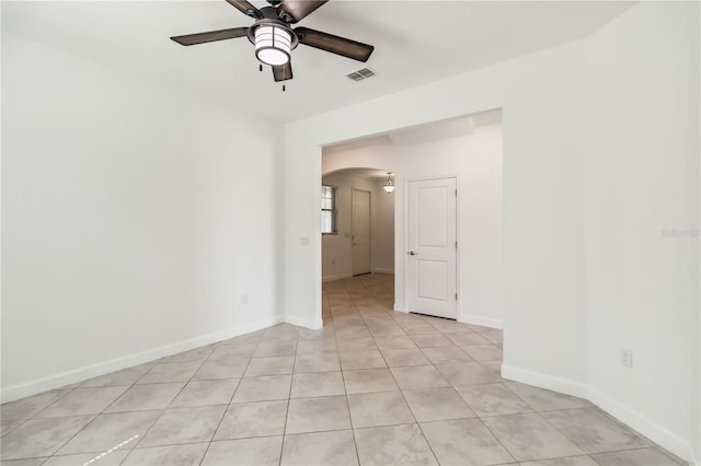 9629 Ivory Dr, Ruskin, FL 33573 - spare room featuring arched walkways, a ceiling fan, and light tile patterned floors