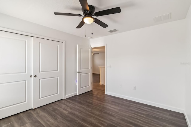 9629 Ivory Dr, Ruskin, FL 33573 - unfurnished bedroom featuring dark wood-style flooring, a closet, and ceiling fan