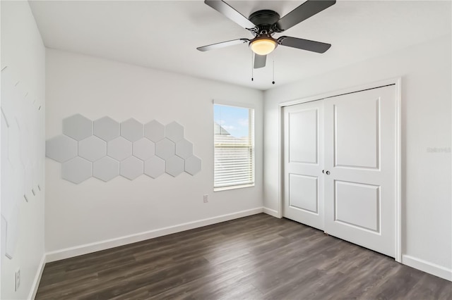 9629 Ivory Dr, Ruskin, FL 33573 - unfurnished bedroom featuring dark wood-style flooring, a closet, and a ceiling fan