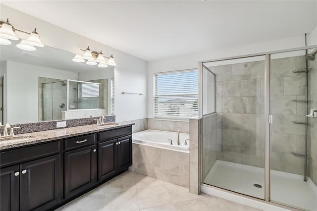 9629 Ivory Dr, Ruskin, FL 33573 - bathroom with double vanity, a garden tub, a stall shower, and tile patterned flooring