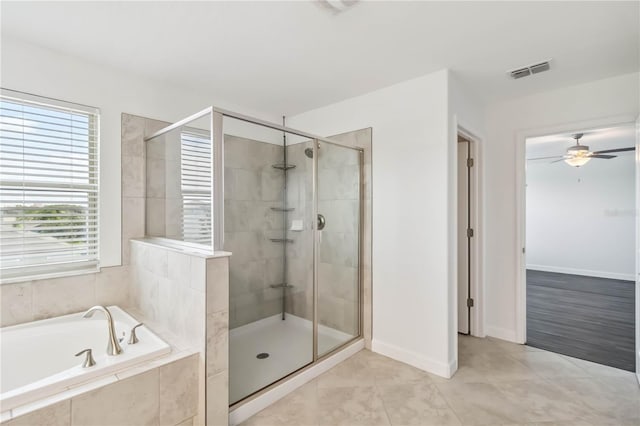 9629 Ivory Dr, Ruskin, FL 33573 - bathroom featuring a garden tub, a shower stall, a ceiling fan, and tile patterned floors