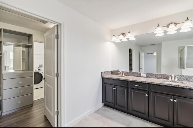 9629 Ivory Dr, Ruskin, FL 33573 - full bath with washer / clothes dryer, double vanity, and a ceiling fan