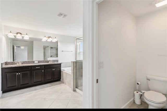 9629 Ivory Dr, Ruskin, FL 33573 - full bath with double vanity, tile patterned floors, a stall shower, and a garden tub